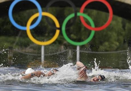 Alex Meyer of the United States (right) and Australia?s Ky Hurst swam past the Olympic rings during the men?s 10k marathon at the 2012 Summer Games.
